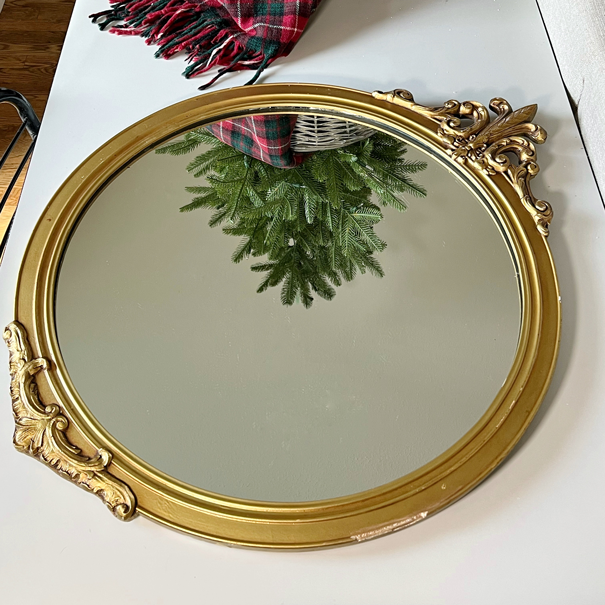 round antique gold mirror with ornate scroll details for Rub'-N-Buff Mirror Makeover