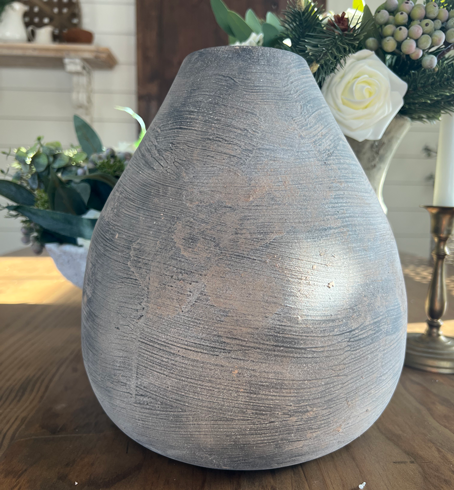 Black teardrop shaped pottery with lines of texture and a chalky finish. DIY vintage pottery in earthenware.