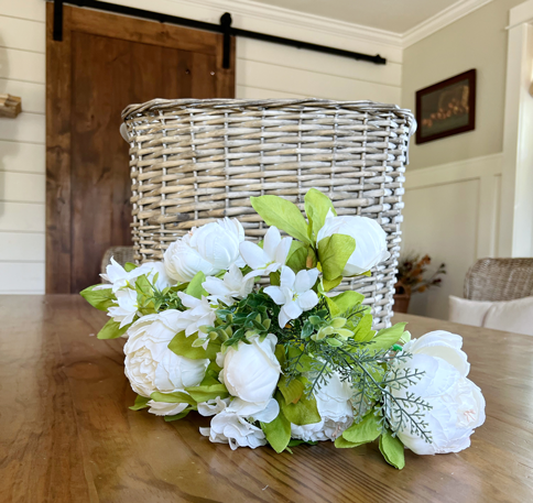 White peony flowers and a wicker market basket. 