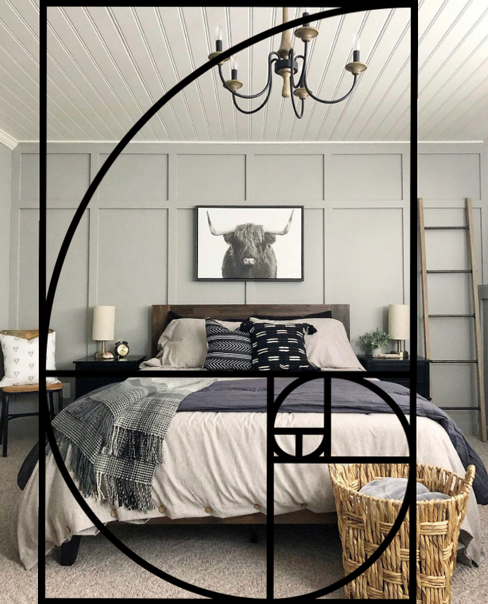 DIY Design and The Golden Ratio in a boys bedroom with gray board and batten walls, a black and white bull painting, bed with neutral bedding and and wood and black chandelier. A rectangle and spiral overlays the picture with items proportionally placed. 