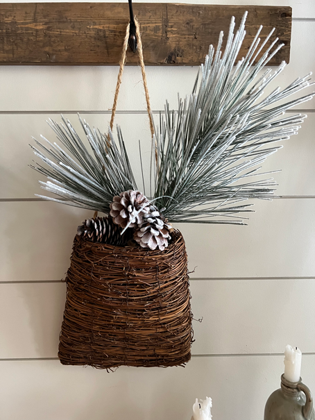 Easy DIY Winter Frosted Pinecones in a basket of frosted pine stems.