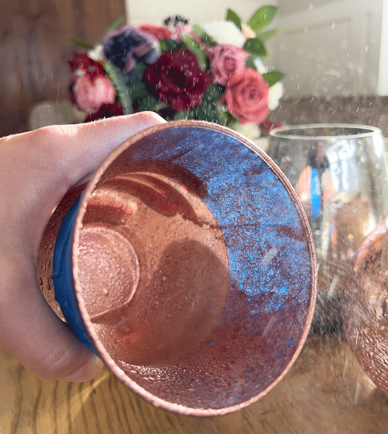 DIY Mercury Glass Votives: photo of a votive taped at the base to prevent over spray and copper spray being sprayed into the votive. 